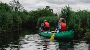 Couple kayaking in wetlands